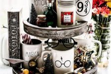 25 a pretty hot chocolate Christmas stand with a Golden Snitch, glasses, potions, beads, deer and faculty emblemsn is amazing