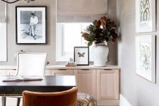 26 a stylish and neutral modern home office with taupe walls, a light-stained credenza, a black desk and a rust-colored round chair