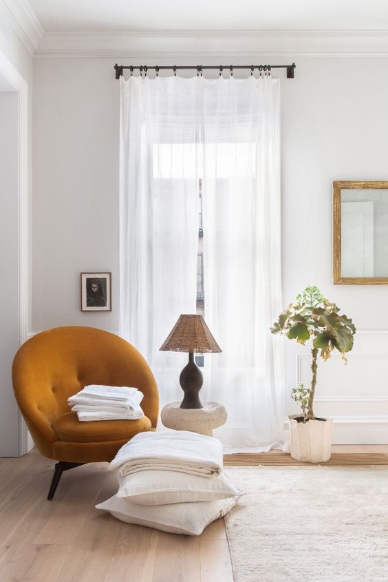 A lovely mustard colored rounded chair will be a cozy and bold accent in your neutral space
