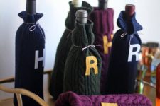 30 sweater wine cozies with monograms are amazing for decorating your drink cart in Harry Potter style