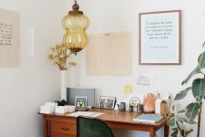 32 a beautiful home office nook with a stained vintage desk and a modern green chair, a lovely vintage pendant lamp and a boho rug