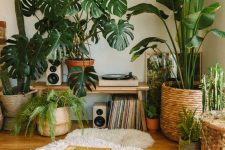38 a beautiful jungle-inspired nook with lots of statement potted plants, cushions and rugs and some vinyl is fabulous