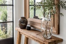 38 a reclaimed wood console table in the entryway gives it a warm and farmhouse feel easily and effortlessly