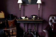40 a vintage aubergine space with dark heavy vintage furniture, a pretty artwork, chic lamps and sconces is elegant