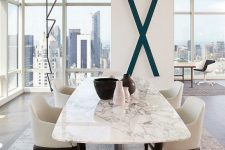 46 a contemporary luxurious dining table with a black base and a white marble tabletop for ultimate chic