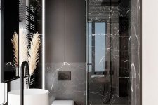 51 a refined minimalist bathroom with black marble tiles, black matte surfaces and white appliances for a bold look