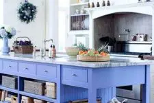 a white kitchen with a colorful kitchen island