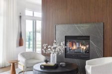 a luxorious living room with a wooden slat wall