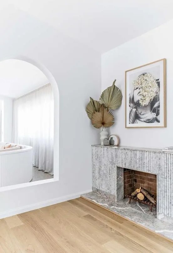 a fireplace with a beautiful marble reeded surround is a stylish addition to a contemporary interior, it looks super chic