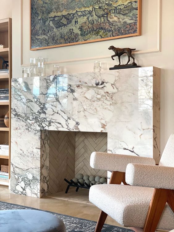 a gorgeous white marble fireplace with some candles on the mantel is a fantastic idea for a sophisticated living room