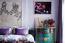 a sophisticated very peri bedroom with vintage teal furniture with painted florals, bold artworks and printed bedding