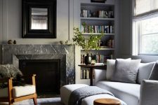 a welcoming neutral living room with a grey marble fireplace and neutral furniture invites people in