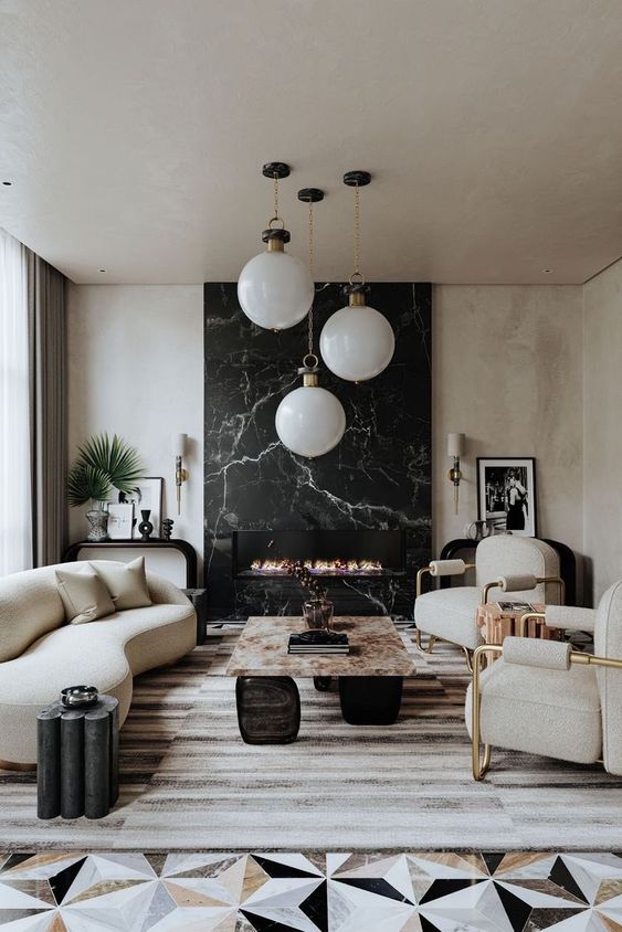 an exquisite living room with a black marble fireplace, neutral curved seating furniture, a stone coffee table and pendant lamps