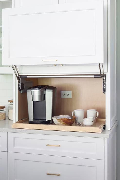 a comfortable coffee station with a raising door and a retractable shelf is a cool idea to hide the bar when not in need
