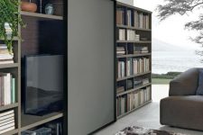 06 a bookcase with a sliding panel that can hide your TV easily and with style is a cool idea for a modern space
