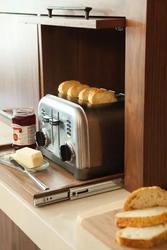 A small retractable shelf and a lifting up cabinet door for hiding the toaster   you can easily get it when needed