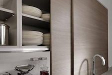 23 sleek sliding doors hiding open storage cabinets with not only appliances but also much other stuff is a genius idea