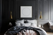 a refined slate grey bedroom with paneling, gold pendant lamps, a bed with grey and pink bedding and an artwork