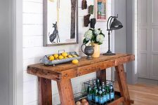 a stained rough wood console table like this one will easily add a cozy farmhouse touch to any space and will make it more welcoming