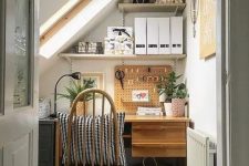 29 a small and cozy attic nook with a desk, a file cabinet, some shelves for storage and lots of plants is a great work spot