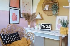 41 a small nook turned into a working space, with a modern desk, shelves, a gallery wall, a round rattan shelf, potted plants and a lovely papasan chair