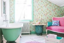 13 a vintage country bathroom with a floral wallpaper wall, a green bathtub, a pink loveseat, a crate with pillows and a side table and bright rugs