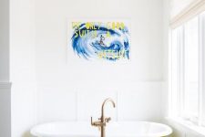 17 a catchy bathroom with a black and white printed floor, a yellow clawfoot tub, a bold artwork and a statement fixture is wow