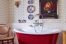 30 a sophisticated vintage bathroom with bold wallpaper and white shiplap, a burgundy bathtub, a colorful rug and plates and an artwork