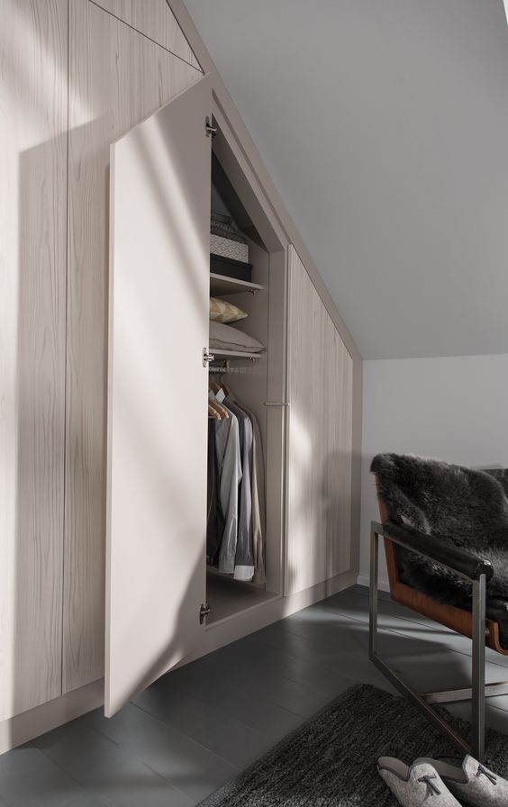 A Scandinavian space with a smart built in attic wardrobe is a lovely idea to repeat, every inch of space is used