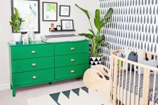 a stylish nursery with an interesting accent wall