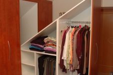 a built-in attic storage unit with oversized drawers and compartments with doors is a smart solution to rock