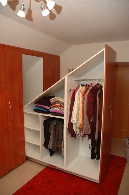 A built in attic storage unit with oversized drawers and compartments with doors is a smart solution to rock