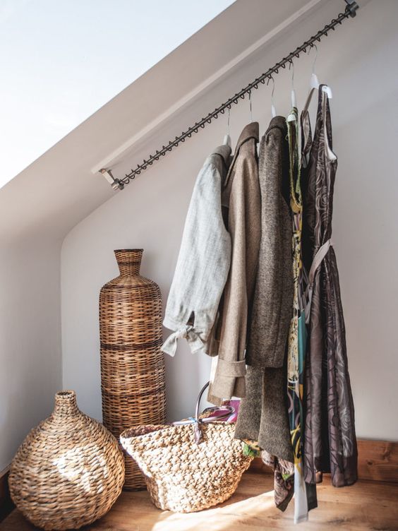 A cool attic storage idea   railing for clothes that makes your outfits part of your home decor or just saves space in the closet