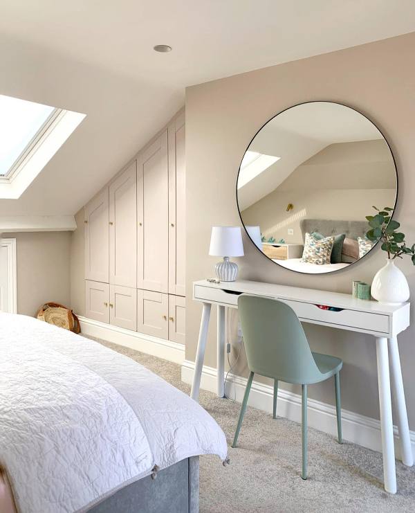A lovely neutral Scandinavian space with a grey built in storage unit in the attic corner is a stylish idea to declutter the room