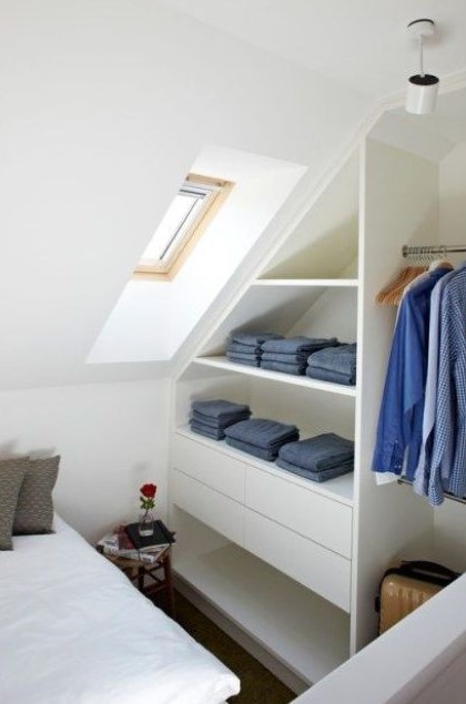 a sleek attic clothes storage item with open shelves and drawers is a stylish and comfortable idea for a small bedroom
