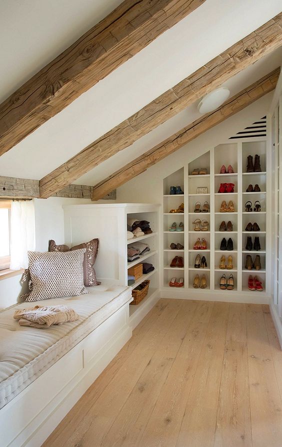 A small yet cozy attic space with a windowsill daybed and built in shoe shelves and clothes shelves is a very cool idea