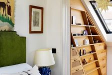 a stylish and very smart attic storage space with an elegant stained built-in shelf and a skylight is amazing