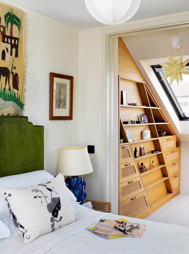 A stylish and very smart attic storage space with an elegant stained built in shelf and a skylight is amazing