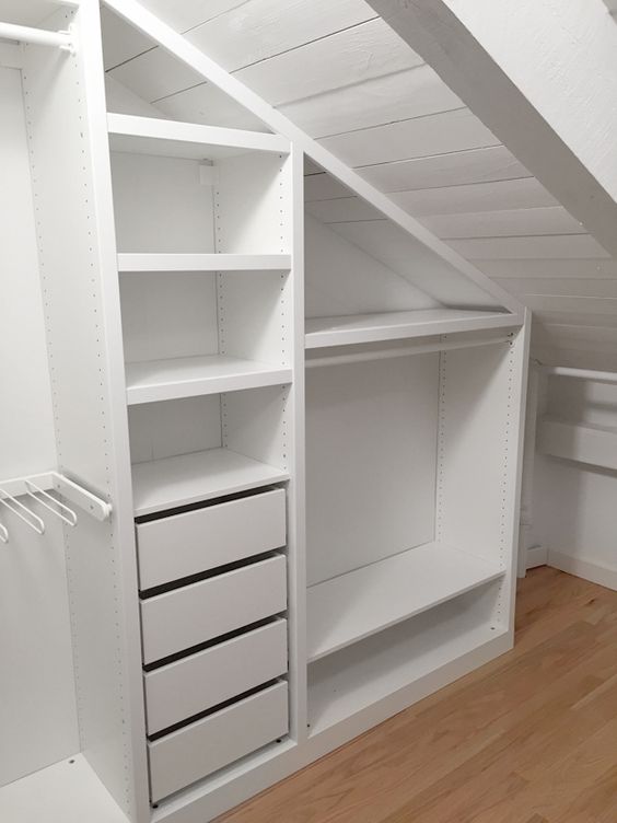 An attic closet with built in storage units, with drawers and open storage compartments is a smart solution to rock