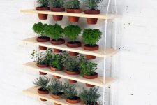 06 a tiered vertical garden with terracotta planters is a lovely idea for a rustic space or a modern one, will fit any outdoor and indoor space