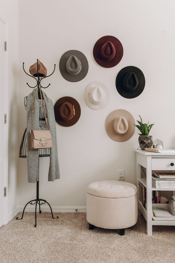 an entryway hat display with hooks on the walls that are hidden by the hats themselves is a lovely idea to add decorative value to the space