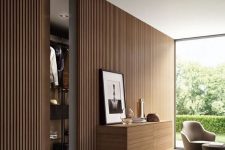 20 a minimalist space with a wood slat accent wall, a floating storage unit with lights, a glazed wall with a garden view