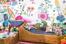 33 a shared colorful kid’s room with a bright floral wall and bold bedding, a bold striped rug and books on the bookshelves