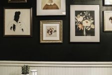 a black and white bathroom with wallpaneling, white appliances and a catchy monochromatic gallery wall