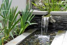 02 a chic modern waterfall going from a bowl with plants into a bowl with feathers and grasses around is a cool idea