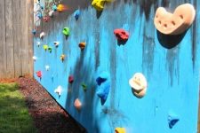 03 a house wall turned into a colorful climbing wall and with a bold wall art is a lovely idea that will make your kids happy