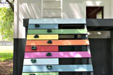 07 a color block playhouse with a ladder to the attic and a colorful ladder with a climbing wall is a veyr fun and cool idea