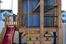 24 an outdoor mini house with ladders, a climbing wall, a red slide and a green swing is a lovely idea for kids’ activities