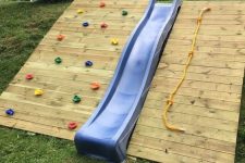 26 a colorful climbing wall, a blue slide and a rope is a simple and cool complex for kids to have fun and activities