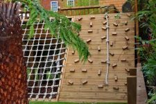 30 a kids’ outdoor play complex with a climbing and rope wall, with a slide and a woven part is a very creative and fun idea to rock